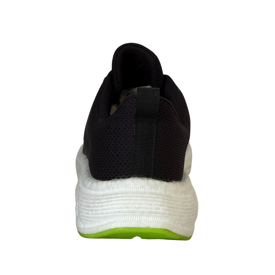 Black and white sneaker with a green sole on a white background WELCOME for 5% OFF