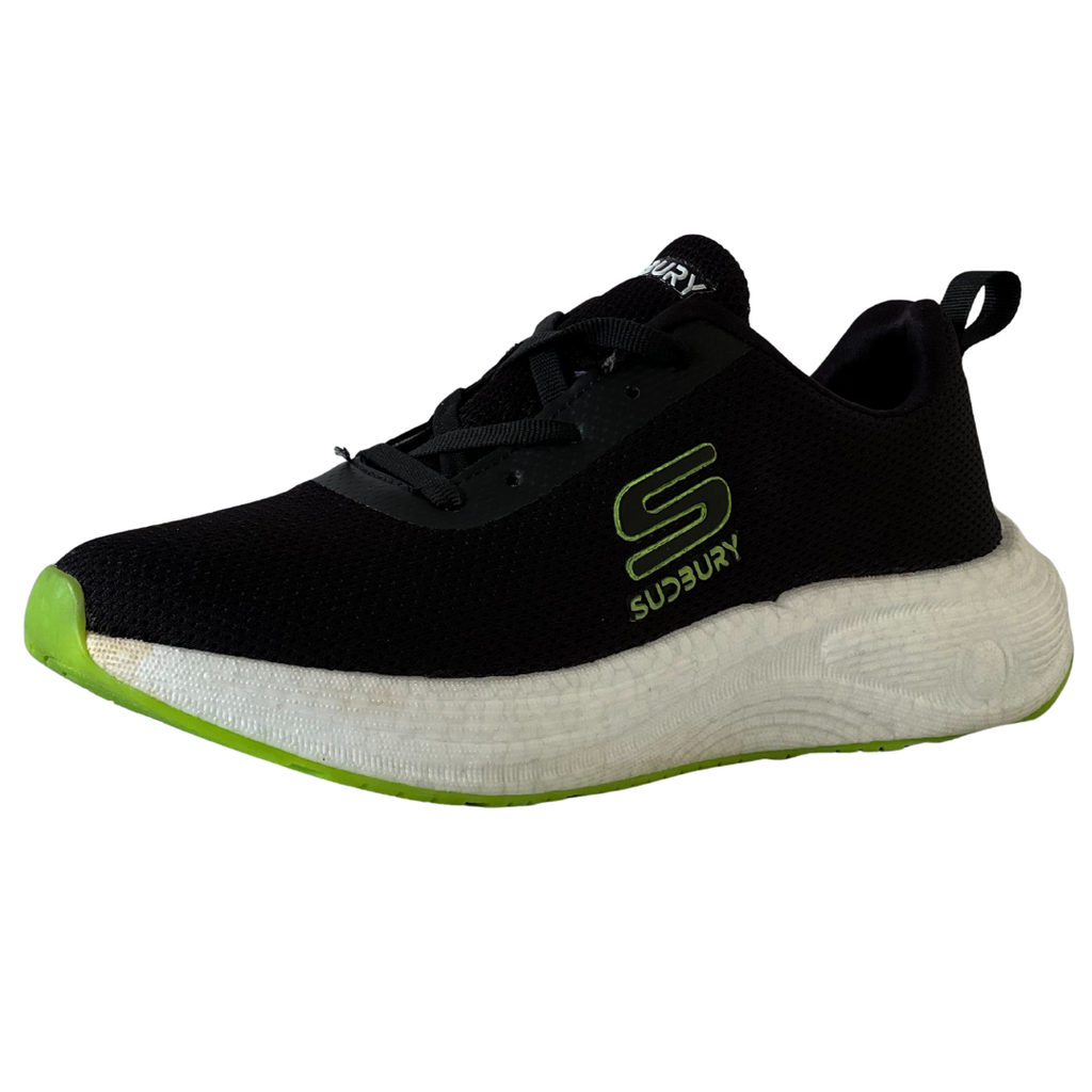 Black sneaker with green sole on a white background
