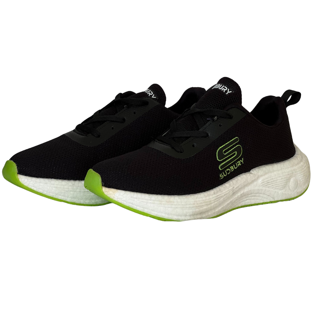 Black sneakers with green soles on a white background