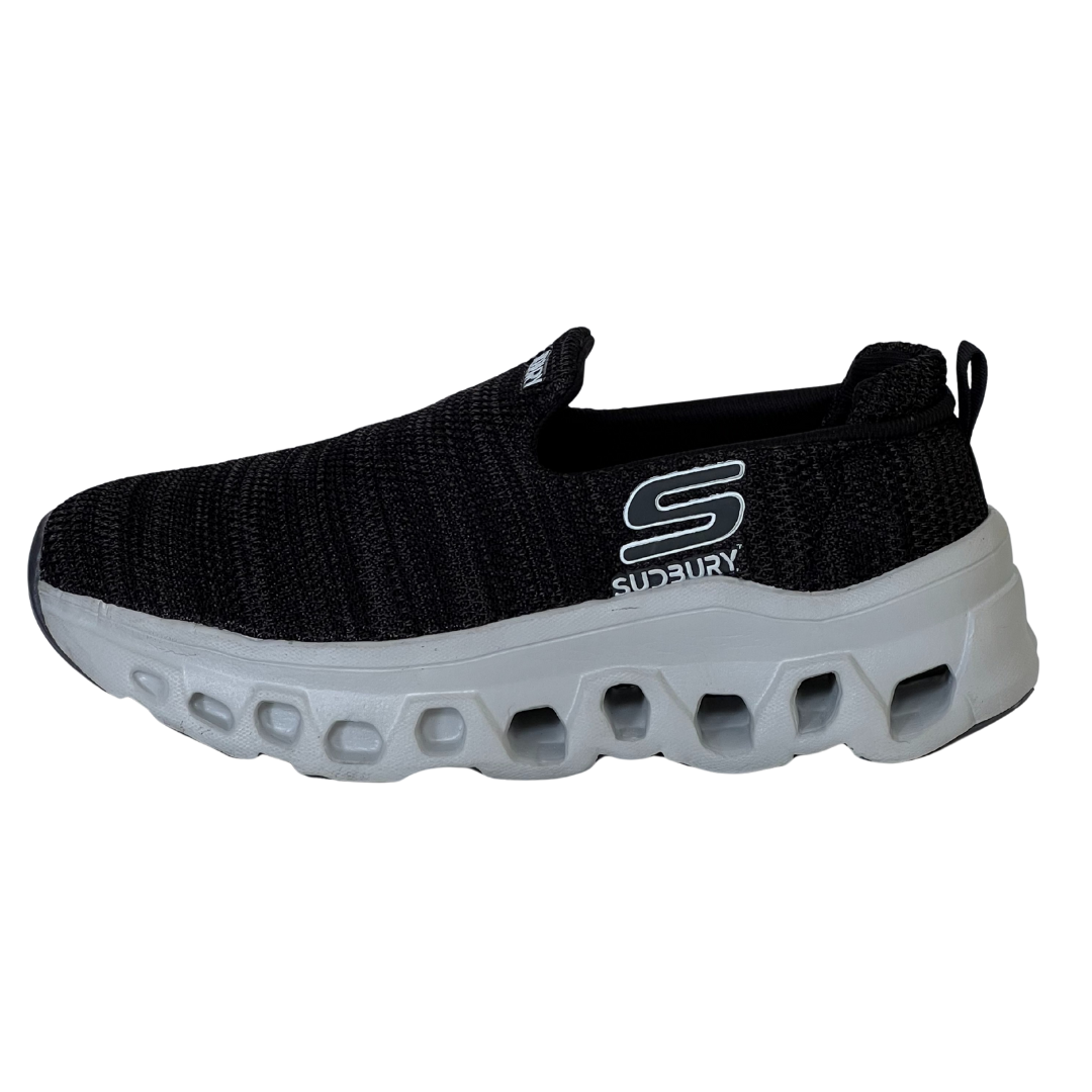 Black slip-on sneaker with white sole on a white background