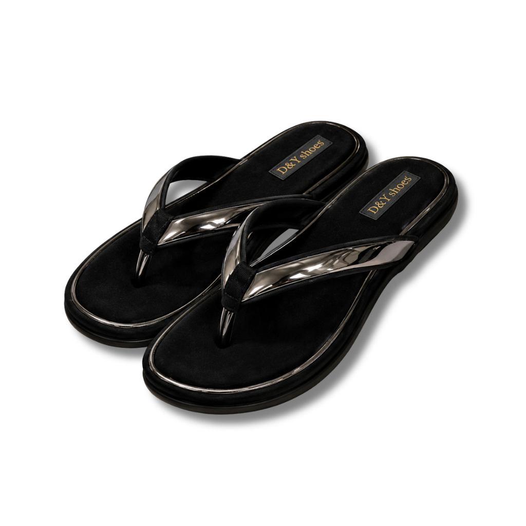 Black flip-flops with metallic toe straps on a white background